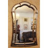 Pair of decorative pier mirrors with gilt metal mounts of shaped form,