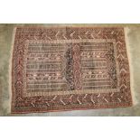 Eastern part silk rug, ochre field with two panels of architectural ornament in geometric borders,