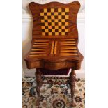 Victorian figured walnut games / sewing table of shaped outline,