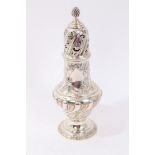 Victorian silver sugar castor of wrythen embossed form with pierced foliate decoration,