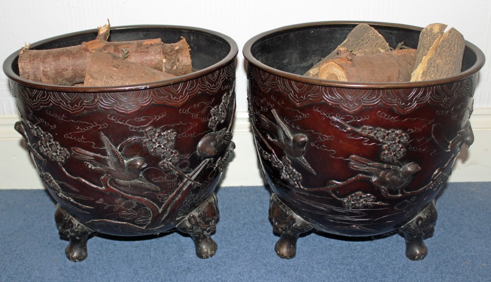 Pair of early twentieth century Japanese bronze jardinières decorated in high relief with birds in