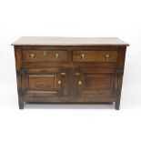 Early 18th century oak dresser base, two drawers over fielded panel cupboard doors,