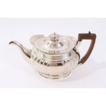 Victorian silver teapot (London 1884) of ribbed bellied form, the domed cover with urn finial,