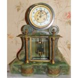 Early twentieth century French green onyx mantel clock of architectural form with exposed