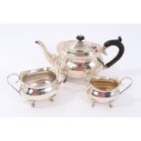 1920s silver three piece teaset of potbellied form on scroll feet, (Birmingham 1929),