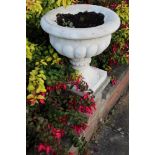 Set of six classical-style concrete garden urns of squat campana form on integral square base,