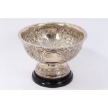 Edwardian silver rose bowl, all over embossed with foliate scrolls and vacant cartouches,