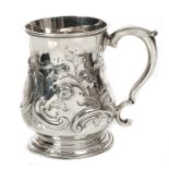 Small late George II silver mug of baluster form, with later embossed scroll and floral decoration,