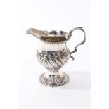 George III silver cream jug of helmet form, with wrythen and floral decoration,