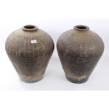 Two antique Continental pottery olive oil jars of baluster form, with incised decoration,