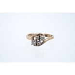 Diamond dress ring with a cluster of four brilliant cut diamonds in a 9ct gold cross-over setting,