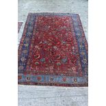 Kashan silk Tree of Life rug with blood-red field in blue meander main border, tassel ends,