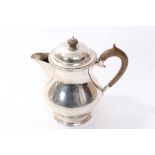 1920s silver hot water jug of baluster form, with sparrow beak spout,