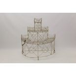 Antique three-tiered wirework plant stand of semi-circular outline with stepped tiers,