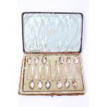 Eleven George V silver teaspoons with bright cut decoration and engraved armorial crest,