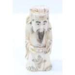 Chinese carved ivory deity figure depicted holding a ruyi sceptre engraved seal, mark to base,