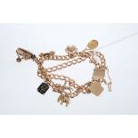 Gold charm bracelet comprising an early 20th century 15ct gold curb link two-strand bracelet