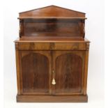 Early Victorian mahogany chiffonier with arched shelf back raised on scrolled supports,