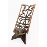 Antique West African birthing chair with pierced figural and animal carved back and slotted seat