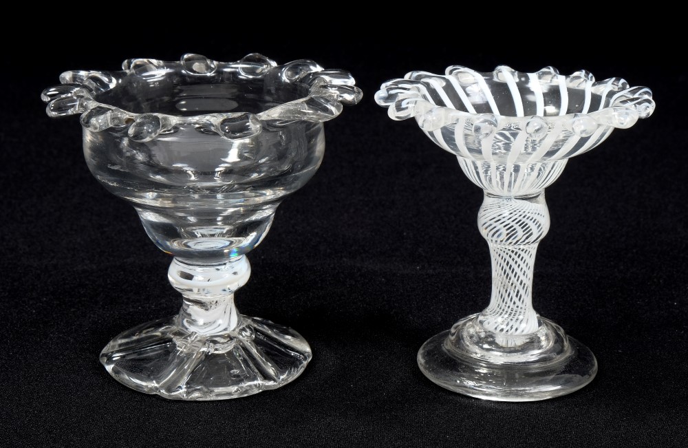 Two 18th century sweetmeat dishes with castellated rims, opaque twist decoration, on splayed foot,