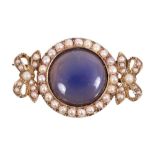 Unusual Edwardian brooch with a blue cabochon stone surrounded by a border of seed pearls and