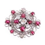 Ruby and diamond cluster brooch with a central cluster of five old cut diamonds alternating with