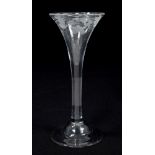Mid-18th century toasting glass with trumpet-shaped bowl, engraved with grapevines,