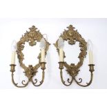 Pair late 19th century brass girondole wall lights each with cartouche form mirrored back with mask