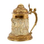 Renaissance style German carved ivory and gilt metal mounted tankard with embossed domed cover and