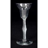 Mid-18th century wine glass with pan-top bowl, swollen air-twist stem on splayed foot,