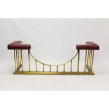Victorian-style brass upholstered club fender with colonnade supports on angular kerb,