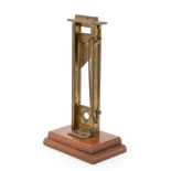 20th century brass model novelty guillotine - possibly a cigar cutter, on wood plinth,
