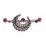 Late Victorian ruby and diamond brooch with a crescent of old cut diamonds on a bar with three