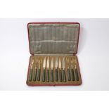 Cased set of six pairs of early 20th century close-plate fruit knives and forks with green agate