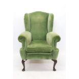 George II-style wing armchair with green velvet upholstery,