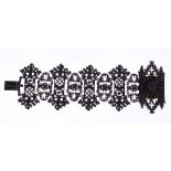 An early 19th century Berlin ironwork bracelet with architectural Gothic pierced panels with