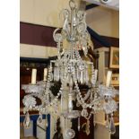 19th century-style cut glass chandelier with central column issuing four scrolled metal branches