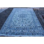 Kashmir carpet with cream ground and central medallion issuing meandering lotus flower ornament,