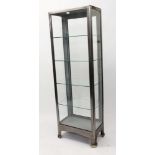 1940s polished steel medical cabinet with four glass shelves with glazed sides, on bracket feet,