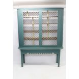 Imposing antique painted pine bookcase with five shelves enclosed by pair of grille doors between