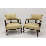 Pair of Edwardian mahogany tub armchairs, cream upholstered with lyre pierced back,