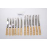 Unusual set of twelve 1920s dinner knives with stainless steel blades and carved elephant tooth