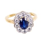 Sapphire and diamond cluster ring, the oval mixed cut blue sapphire measuring approximately 7.