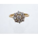 Diamond cluster ring with a flower-head cluster comprising eight old cut diamonds estimated to