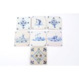 Seven 18th century Delft blue and white tiles with painted building decoration