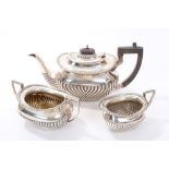 Edwardian silver three piece tea set - comprising teapot of half-fluted form, with gadrooned border,