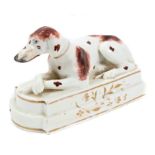 Early 19th century English porcelain figure of a seated liver-spotted hound,