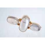 Edwardian moonstone brooch and three oval cabochon moonstones in gold rub-over setting, stamped 9ct,
