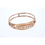 Edwardian 9ct rose gold hinged bangle with pale blue sapphires and rose-cut diamonds on star-shape