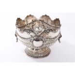 Edwardian silver monteith of half-fluted form with floral swag decoration, two vacant cartouches,